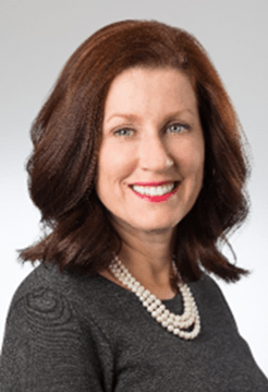 Maryanne Adams, President & CEO, Avalon Flooring, smiling and wearing a grey top with a pearl necklace
