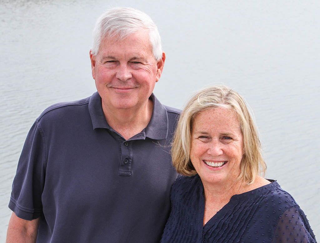 Dave and Monica Coskey stand together smiling at the camera